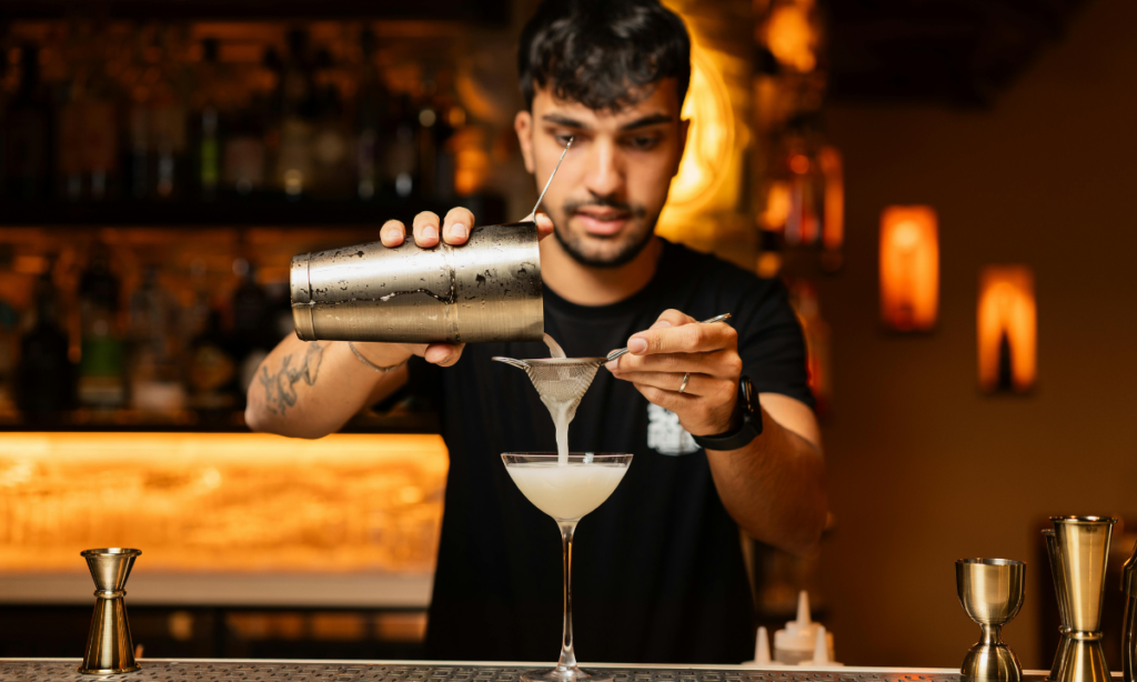 a bertender serving a cocktail 